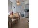 Bright dining area with a ceiling fan, window, dining table, and four upholstered chairs at 11251 80Th Ave # 210, Seminole, FL 33772