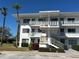 Clean, white, three-story condo building featuring balconies and well-maintained landscaping at 11251 80Th Ave # 210, Seminole, FL 33772