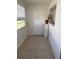 Enclosed porch hallway area with vinyl floor, a window, and a white door at 11251 80Th Ave # 210, Seminole, FL 33772