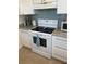 White kitchen cabinets with a white range, tile backsplash, and granite countertops at 11251 80Th Ave # 210, Seminole, FL 33772