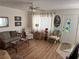 Comfortable living room features a ceiling fan, sofas, chairs, and view of the entry door at 11251 80Th Ave # 210, Seminole, FL 33772