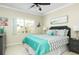 Cozy bedroom featuring a large window, stylish décor, and a comfortable queen-sized bed at 11680 Shipwatch Dr # 1454, Largo, FL 33774