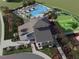 Aerial view of community pool, clubhouse, walking paths, and green spaces at 129 Whiteland Bnd, Nokomis, FL 34275