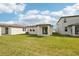 Backyard featuring a well-maintained lawn and a covered patio for outdoor living at 129 Whiteland Bnd, Nokomis, FL 34275