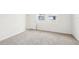 Spacious bedroom with bright windows and access door and neutral carpeting at 129 Whiteland Bnd, Nokomis, FL 34275