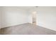 Bedroom with an open doorway, access to bathroom and neutral carpeting at 129 Whiteland Bnd, Nokomis, FL 34275