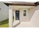 A close up on a home's front door and adjacent window with a modern design and covered porch at 129 Whiteland Bnd, Nokomis, FL 34275