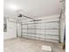 Spacious two car garage featuring a finished concrete floor and metal garage door at 129 Whiteland Bnd, Nokomis, FL 34275