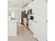 View of kitchen featuring stainless steel appliances, white cabinets, and an island with a sink at 129 Whiteland Bnd, Nokomis, FL 34275