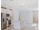 A modern kitchen boasts stainless steel appliances, a functional island, and an open layout at 129 Whiteland Bnd, Nokomis, FL 34275