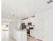 Modern kitchen boasting stainless steel appliances, an island with a sink, and white cabinetry at 129 Whiteland Bnd, Nokomis, FL 34275
