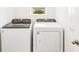 The laundry room contains a white Whirlpool washer and dryer set at 129 Whiteland Bnd, Nokomis, FL 34275