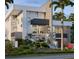 Stunning modern home featuring clean lines, multiple stories, and lush tropical landscaping at 1310 Boca Ciega Isle Dr, St Pete Beach, FL 33706