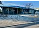 Cozy single-story home with a light blue metal roof and driveway at 1310 Boca Ciega Isle Dr, St Pete Beach, FL 33706