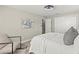 Well-lit bedroom with large windows, minimalist decor, and plush bedding at 1464 S Evergreen Ave, Clearwater, FL 33756