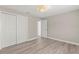 Empty bedroom featuring hard wood floors, spacious closet doors, and natural light at 1464 S Evergreen Ave, Clearwater, FL 33756