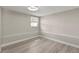 This bedroom offers neutral walls, wood-look floors and one window at 1464 S Evergreen Ave, Clearwater, FL 33756