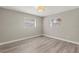 This bedroom features neutral walls, wood-look floors and two windows at 1464 S Evergreen Ave, Clearwater, FL 33756
