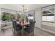 Bright dining area with large windows offering pool views and modern pendant lighting fixture at 1464 S Evergreen Ave, Clearwater, FL 33756