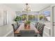 Dining area featuring a pool view from the many windows, a modern light, and stylish dining set at 1464 S Evergreen Ave, Clearwater, FL 33756