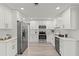 Bright kitchen features white cabinetry, stainless steel appliances, and modern countertops at 1464 S Evergreen Ave, Clearwater, FL 33756