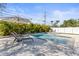 Backyard pool with lounge chairs, umbrella, tile detail and privacy landscaping at 1464 S Evergreen Ave, Clearwater, FL 33756
