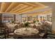 Elegant ballroom setup with round tables, chairs, and ocean views through windows at 15000 Madeira Way # 518, Madeira Beach, FL 33708