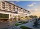 Elegant building exterior with pedestrian plaza and lush landscaping near parking at 15000 Madeira Way # 518, Madeira Beach, FL 33708