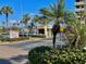 A well maintained entrance to a waterfront community with lush landscaping and signage at 1616 Sand Key Estates Ct, Clearwater Beach, FL 33767