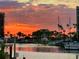 Beautiful sunset view over the water showcasing the docks and waterfront condos at 1616 Sand Key Estates Ct, Clearwater Beach, FL 33767