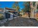 Backyard with shed, mature tree, and partial fence on a sunny day at 1633 Clearview Ave, Clearwater, FL 33756