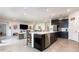 Open concept kitchen with stainless steel appliances and center island flows into the living room at 18019 Fattoria Ter, Bradenton, FL 34211