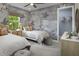 Charming bedroom with two twin beds, unique wallpaper, and a walk-in closet at 18585 Watercolor Ave, Venice, FL 34293