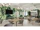 Bright clubhouse featuring a television, tropical leaf wall coverings, games, and tables with seating at 18585 Watercolor Ave, Venice, FL 34293