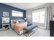 Stylish main bedroom with accent wall and ample natural light at 2007 Wild Heron Ct, Valrico, FL 33596