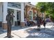 Dunedin History Museum shows sculptures, red brick, white trim, black windows, and a slice of life on a sunny day at 2034 Nolan Dr, Dunedin, FL 34698