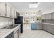 Functional kitchen with skylight, blue oven, and tile countertops at 2034 Nolan Dr, Dunedin, FL 34698