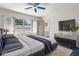 This main bedroom boasts a large bed, sleek furniture, and plenty of natural light at 2034 Nolan Dr, Dunedin, FL 34698