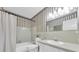 Bathroom features a shower, vanity, toilet and striped wall paper at 2170 Americus S Blvd # 6, Clearwater, FL 33763