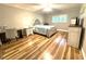 Primary bedroom with wood floors, stylish furniture, ceiling fan, and natural light at 2170 Americus S Blvd # 6, Clearwater, FL 33763