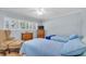 Bright bedroom with two beds, wood floors, windows and a television at 2170 Americus S Blvd # 6, Clearwater, FL 33763