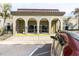 Community clubhouse entrance with covered walkway and well-maintained landscaping at 2170 Americus S Blvd # 6, Clearwater, FL 33763