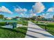 A well-maintained walkway with picnic tables and lush landscaping in a vibrant community park at 2170 Americus S Blvd # 6, Clearwater, FL 33763