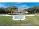 Community's decorative fountain surrounded by lush greenery and trees at 2170 Americus S Blvd # 6, Clearwater, FL 33763