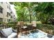 Cozy outdoor patio with chairs, table, and a view of the lush landscaping at 2170 Americus S Blvd # 6, Clearwater, FL 33763