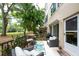 Cozy outdoor patio with furniture, a grill, and a view of the landscaping at 2170 Americus S Blvd # 6, Clearwater, FL 33763
