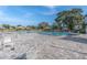 Large outdoor swimming pool area with brick patio and plenty of lounge chairs at 2170 Americus S Blvd # 6, Clearwater, FL 33763