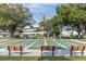 Multiple shuffleboard courts surrounded by trees and benches at 2170 Americus S Blvd # 6, Clearwater, FL 33763