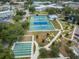 Aerial view of tennis and shuffleboard courts, alongside walkways and a pond, in a beautiful community at 2170 Americus S Blvd # 6, Clearwater, FL 33763