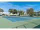 Well maintained tennis courts with blue playing surface in a community with landscaped grounds and residences at 2170 Americus S Blvd # 6, Clearwater, FL 33763
